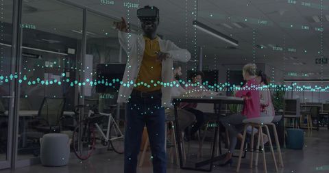 Man with vr headset interacting with data in modern office