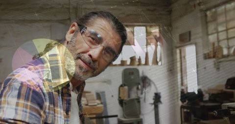 Craftsman in Workshop Holding Wooden Plank Wearing Protective Eyewear