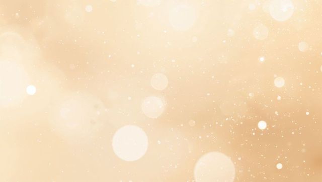 Glowing soft beige bokeh background featuring warm golden light and sparkle