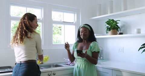Diverse Friends Enjoying Culinary Moments Together in Modern Kitchen