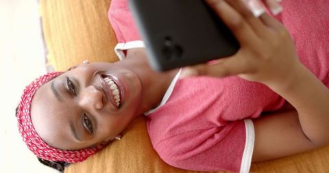 Smiling African American Woman Using Smartphone Comfortably