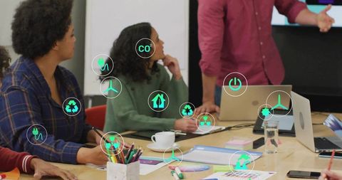 Team presenting sustainable energy strategy in collaborative boardroom with eco icons