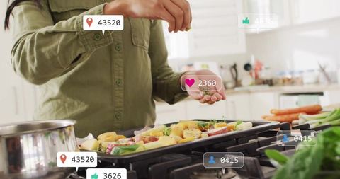 Home cooking influencer sprinkling herbs on roasting vegetables with social media likes