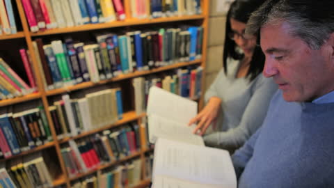 Man and Woman Studying in a Library