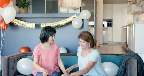 Diverse Senior Women Celebrating Birthday in Modern Living Room