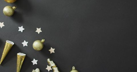Festive Gold Baubles and Stars on Black Background for New Year
