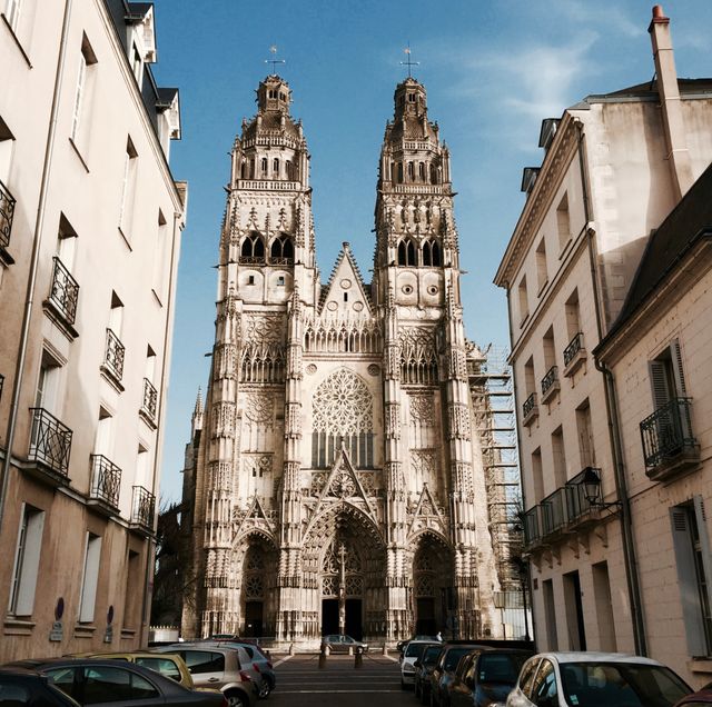 This depicts an impressive Gothic cathedral with twin towers and detailed stonework under a clear blue sky. Use in travel-related content, architectural studies, European culture exploration, religious or historic education.