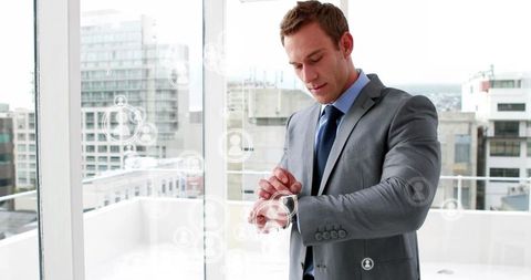 Executive reviewing time in modern office overlooking city