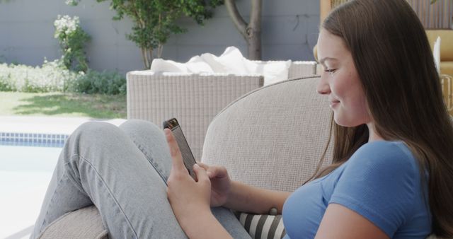 Teen Girl Smiling and Using Smartphone by Poolside - Download Free Stock Images Pikwizard.com