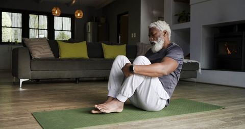Senior Man Practicing Yoga for Mindful Wellness at Home