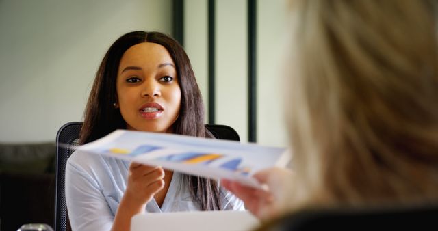 Businesswoman Discussing Financial Graph in Office Meeting - Download Free Stock Images Pikwizard.com