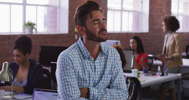 Stressed Businessman Taking Break in Busy Open Office - Download Free Stock Images Pikwizard.com