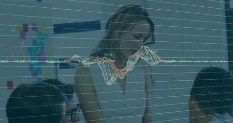 Businesswoman analyzing graphs with team investing in growth