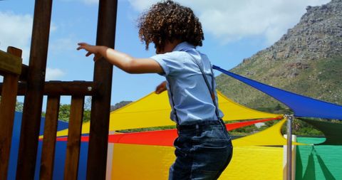 Energetic Boy Enjoying Vibrant Outdoor Playground