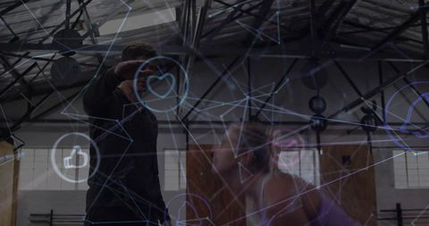 Coach guiding athlete during high-intensity workout in industrial gym with digital overlay