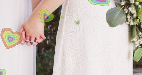 Loving Same-Sex Wedding Couple Holding Hands With Floating Hearts