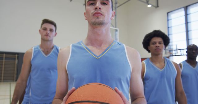 Basketball team with players in blue uniforms posing in indoor court - Download Free Stock Images Pikwizard.com