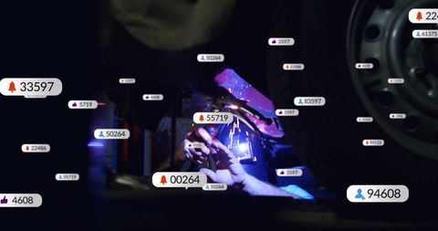 Skilled Mechanic Welding Under Car Lift with Digital Interaction