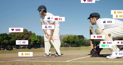 Standing batsman and crouching wicketkeeper on sunny cricket pitch with social media icons
