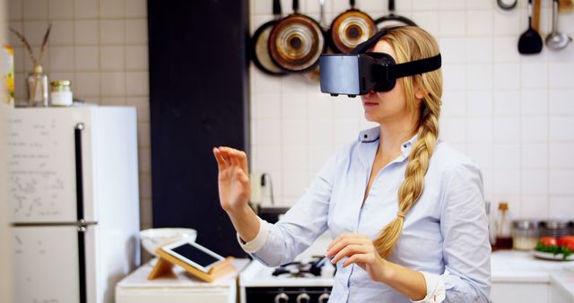 Woman using virtual reality headset in kitchen at home