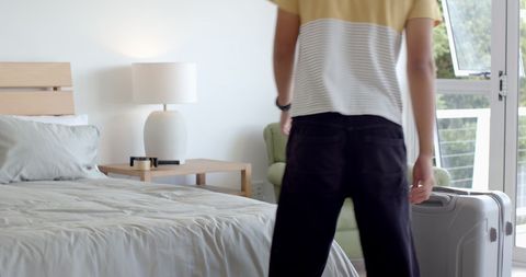 Casual Morning Routine in Cozy Bedroom with Luggage