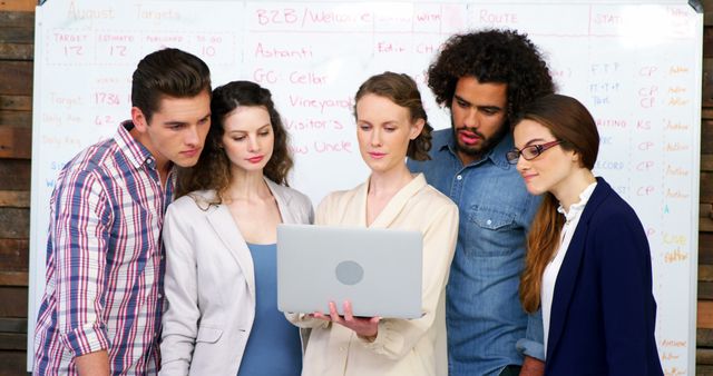 Diverse Team of Professionals Collaborating on Laptop in Office - Download Free Stock Images Pikwizard.com