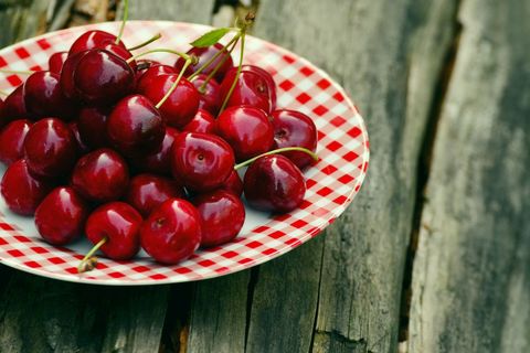 Fresh ripe cherries on rustic wooden table for cherry background