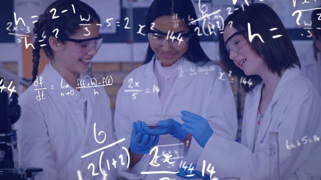 Great for educational materials, promoting STEM careers for girls, articles on hands-on learning techniques in science, or advertising for school science programs. This depicts enthusiasm for chemistry and teamwork among young students.