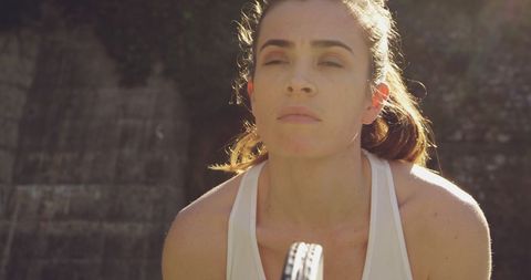 Focused young woman during intense outdoor workout