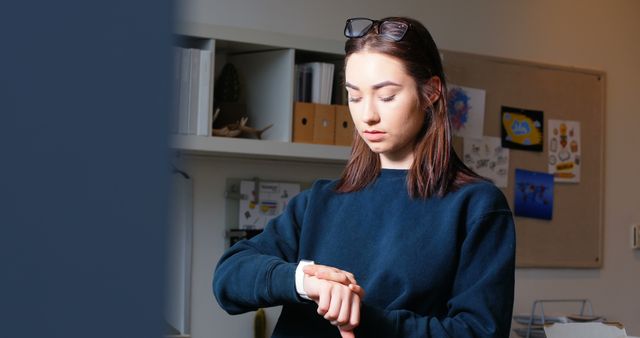 Young Woman Checking Wristwatch in Modern Office - Download Free Stock Images Pikwizard.com