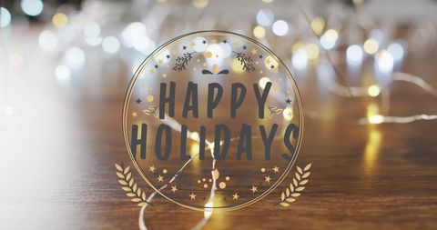 Happy Holidays Text with Festive Lights and Wooden Surface