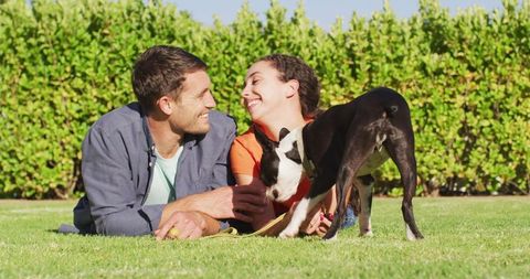 Couple Enjoying Quality Time with Dog Outdoors
