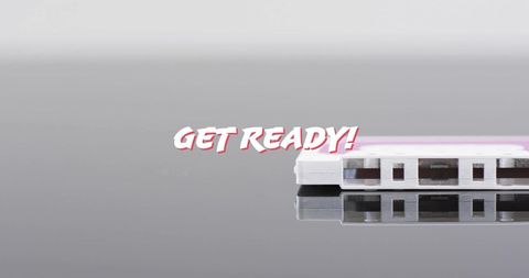 Retro cassette tape with get ready text on reflective surface