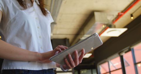 Businesswoman Engaging with Tablet Technology in Modern Office
