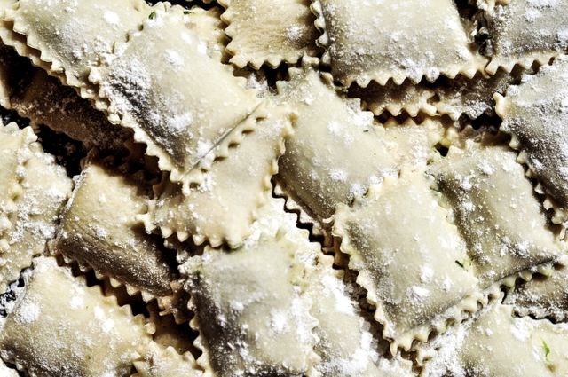 Freshly made ravioli with a light dusting of flour, perfect for concepts of homemade cooking, traditional Italian dishes, or culinary preparation. Useful for blogs, recipe sites, and culinary magazines focused on Italian cuisine or pasta-making.