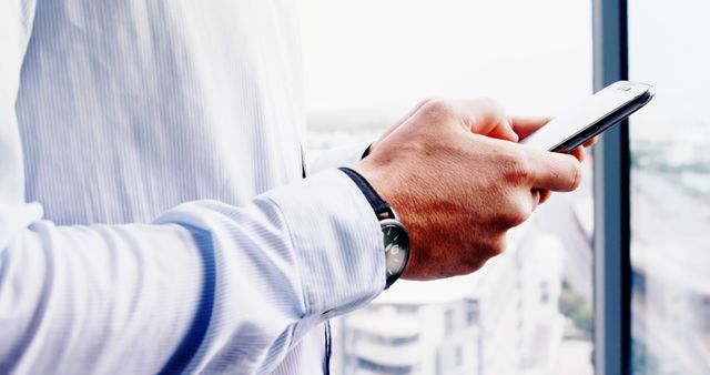 Businessman Checking Messages on Smartphone by Window - Download Free Stock Images Pikwizard.com