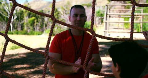 Trainer Encouraging Children on Obstacle Course in Outdoor Boot Camp - Download Free Stock Images Pikwizard.com