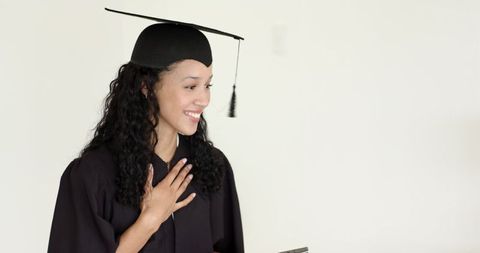 Graduate Smiling with Congratulations Card Celebrating Achievement