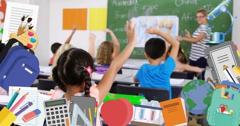 Teacher pointing at map as students raising hands in elementary classroom with supplies
