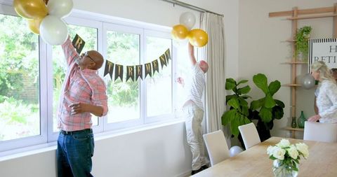 Seniors Decorating for Joyful Retirement Celebration with Friends