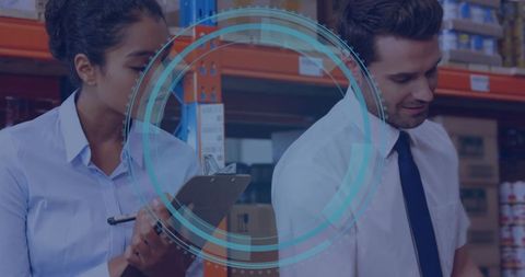 Warehouse Professionals Analyzing Inventory with Digital Interface