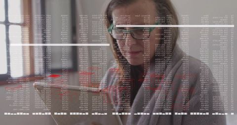 Focused businesswoman analyzing tablet with code columns and red analytics overlay