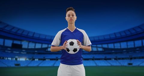 Confident Female Soccer Player Holding Ball in Stadium - Download Free Stock Images Pikwizard.com