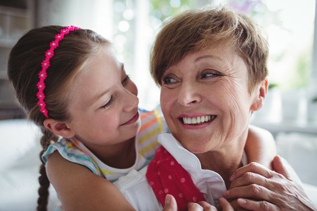 Granddaughter Embracing Grandmother with Love at Home - Download Free Stock Photos Pikwizard.com