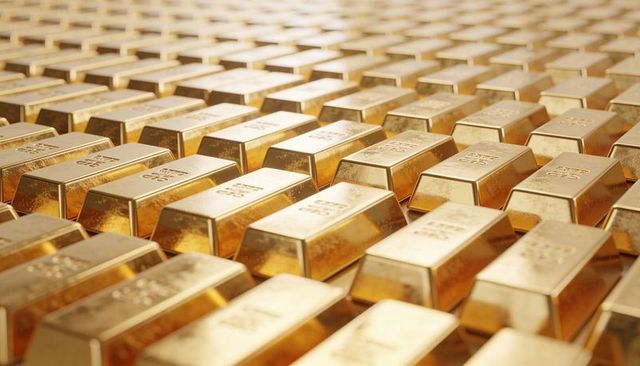 Glinting gold bullion bars stacking in staggered vault grid with stamped purity marks
