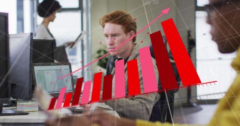 Caucasian Man Analyzing Financial Growth on Computer at Office