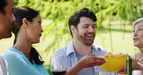 Diverse Group Enjoying Outdoor Picnic with Laughter