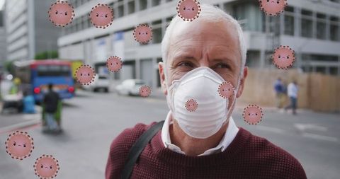 Senior man wearing protective mask amid falling virus illustrations on street