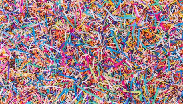 Bursting with color confetti cascade close-up multicolored shredded paper streamers texture