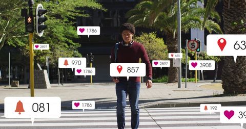 Man engaged with social media notifications while walking